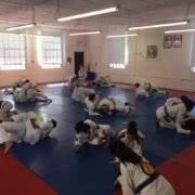 A group of people in a room with some type of mat.