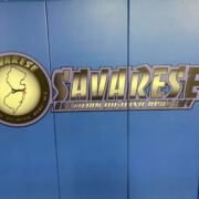 A blue wall with a clock and the word " sunrise ".