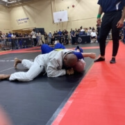 A man in white and blue uniform on ground.