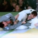 A man in grey and white uniform wrestling.