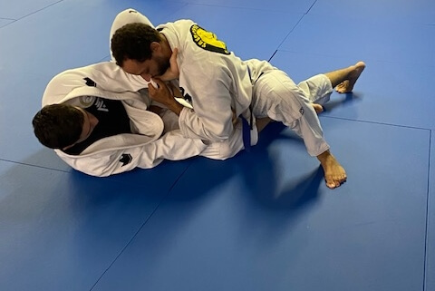 A man is doing judo on the ground