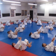 A group of people in white uniforms practicing martial arts.