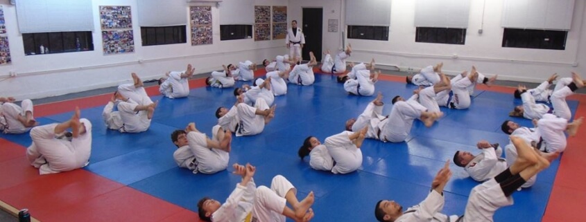 A group of people in white uniforms practicing martial arts.