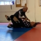 A man is wrestling another man on the ground.
