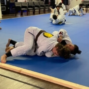 A person is doing judo on the ground