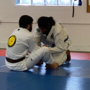 Two men sitting on the ground in a room.