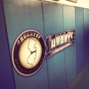 A wall with a clock and the words " thunder " on it.