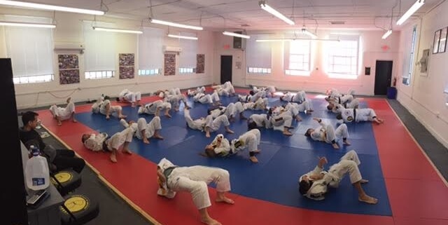 A group of people in white uniforms practicing judo.