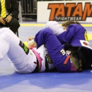 A person in white and blue uniform on the ground.