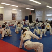 A group of people in white and blue uniforms practicing martial arts.