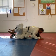 A person is doing judo on the ground