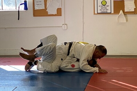 A person is doing judo on the ground