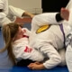A woman is on the ground in a judo match.