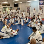 A group of people sitting on the floor in a room.