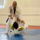 A man is doing judo moves on another person.