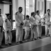 A group of people standing in front of windows.