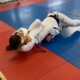 A person is doing judo on the ground