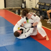 A man is doing a judo move on another person.